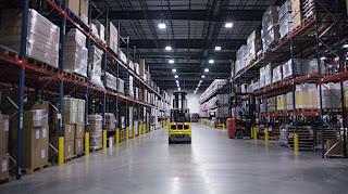 A forklift operating in a busy warehouse captured with a wide-angle lens.