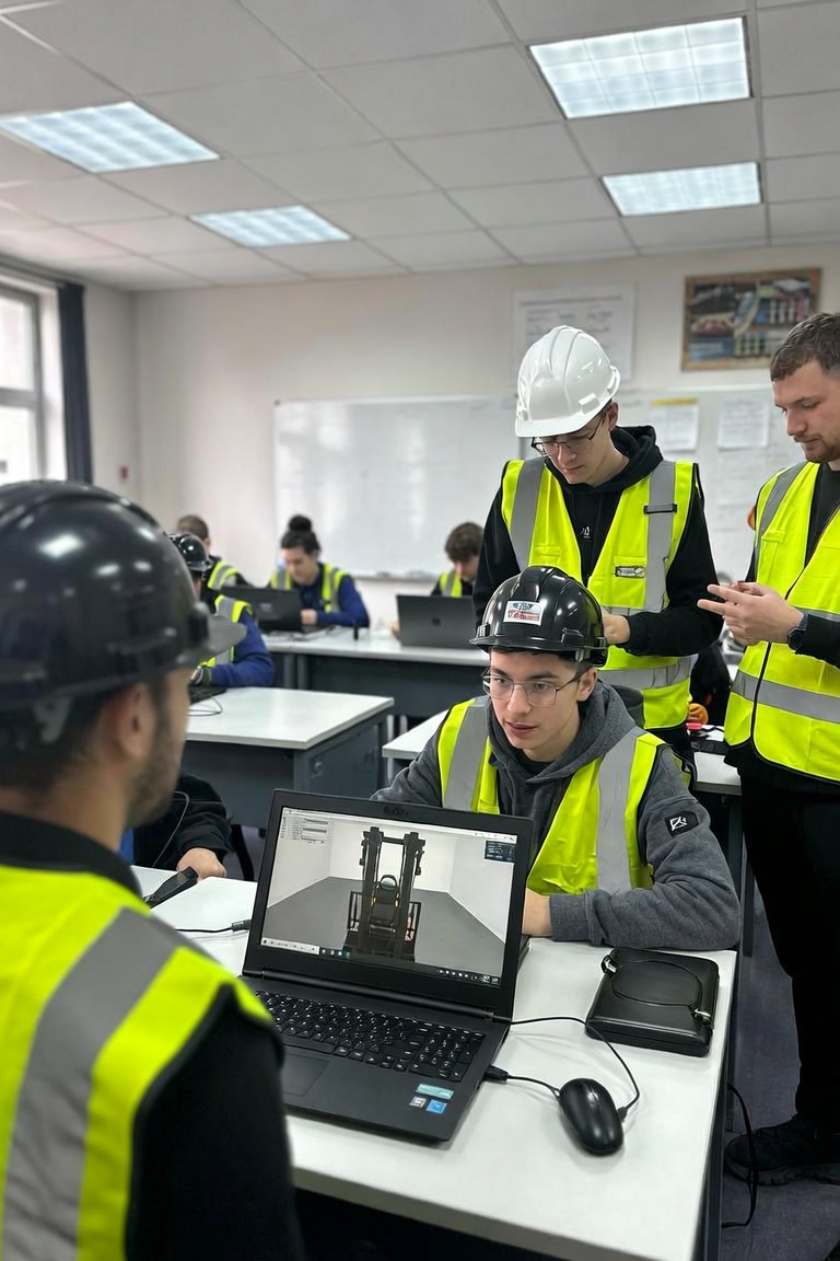 Forklift Academy trainer helping a class of workers in safety vests